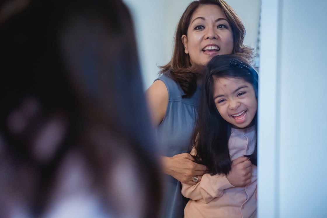 mother-and-daughter-looking-in-mirror