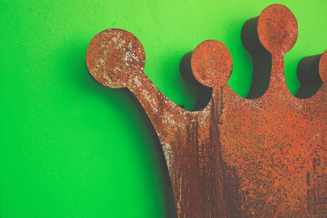 Rusty crown against a bright green background