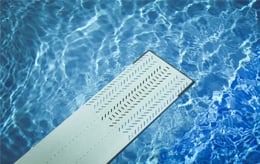 Diving board over pool