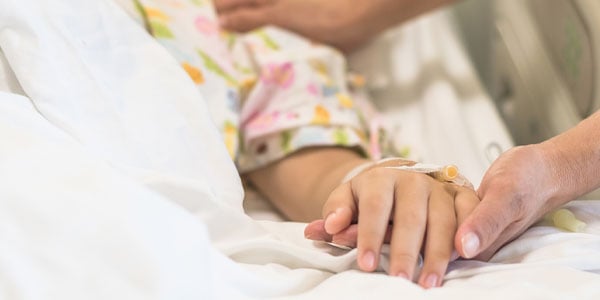 Nurse holding child's hand
