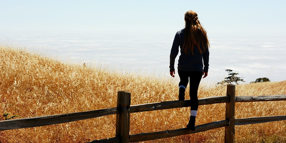 woman_climbing_fence