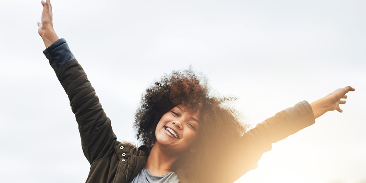 woman_joyful_raising_arms