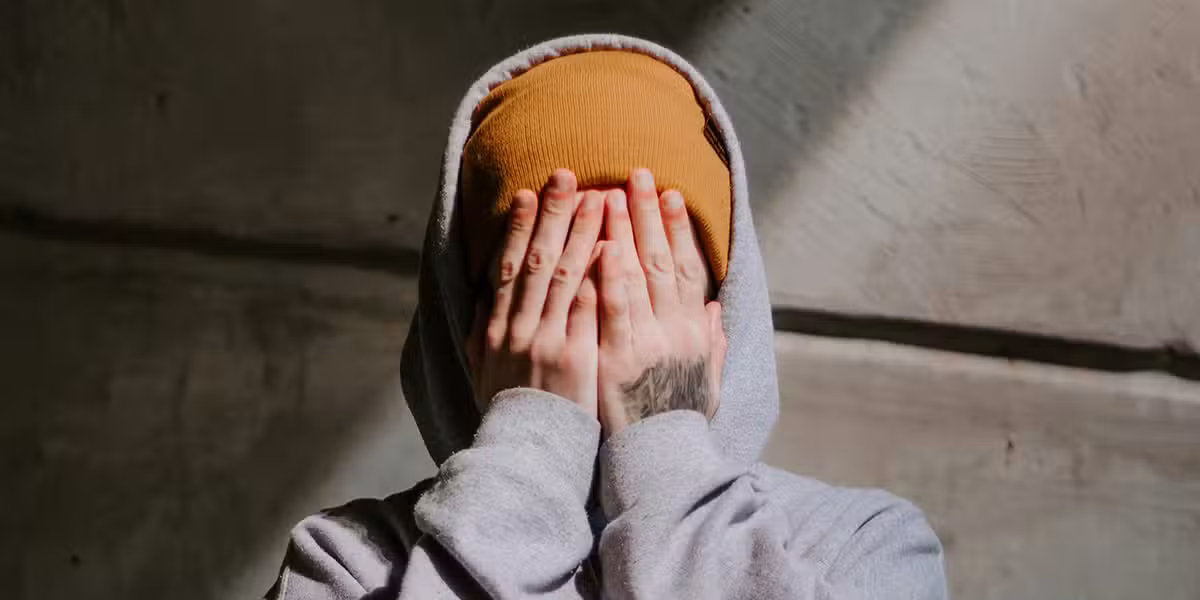 man_covering_face