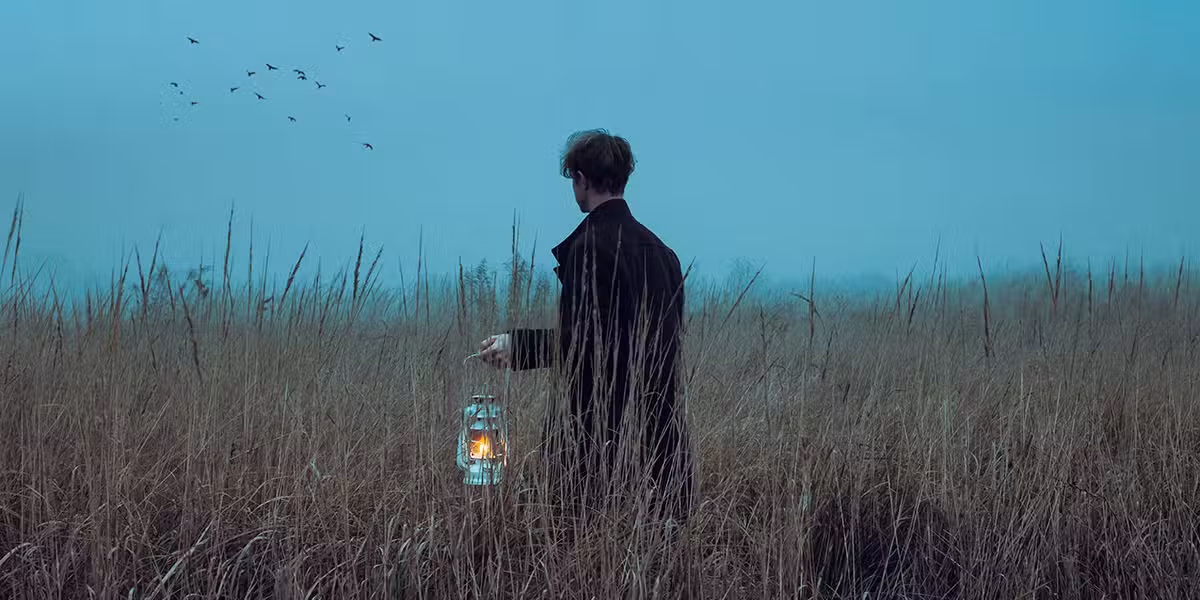 man_lantern_field
